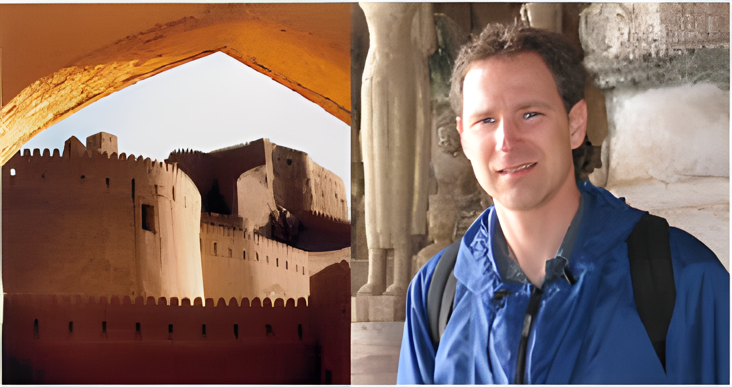 Tobb Dell'Oro with backpack beside an ancient structure